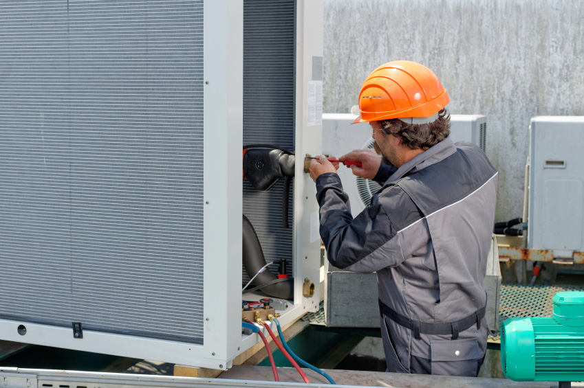 photo of technicians repairing ac 